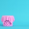 Pink stiched pedestal covered by fabric on bright blue background in pastel colors