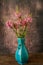 Pink stock flower in a blue vase