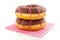 Pink striped donuts with chocolat on napkin