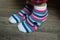 pink stripped socks on feet of woman at home