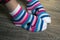 Pink stripped socks on feet of woman at home