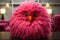 A pink stuffed bird sitting on top of a table