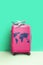 Pink Suitcase world map and airplane model, minimal creative travel concept