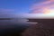 Pink sunset cloud reflection over Santa Clara river seaside marsh at Ventura beach in California USA