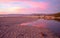 Pink sunset cloud reflection over Santa Clara river seaside marsh at Ventura beach in California USA