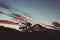 Pink sunset clouds over the mountains with eucalyptus gum trees silhouettes shot in Tasmania