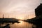 Pink sunset over the mountains and marina with moored yachts