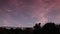 Pink sunset and shooting star filmed in timelapse.