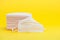 Pink surgical masks for protection against Coronavirus COVID-19 and other contagious diseases. Isolated on yellow background