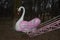 Pink swan on a carousel in an abandoned playground
