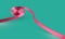 Pink swirly ribbon on green background, vector