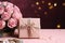 Pink table hosts Mother\\\'s Day: Rose, kraft gift box in chic arrangement.