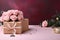 Pink table hosts Mother\\\'s Day: Rose, kraft gift box in chic arrangement.