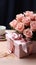 Pink table hosts Mother\\\'s Day: Rose, kraft gift box in chic arrangement.