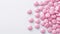 Pink tablet pills neatly arranged on a white background, symbolizing medical care and well-being, Ai Generated