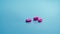 Pink tablets on blue background. Painkiller medicine. Ibuprofen tablets pills. Pharmaceutical industry. Drug for treatment