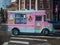 Pink and teal ice cream shake sundae truck van on a street in Ne