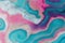 Pink and teal liquid ink swirl abstract background with ravishing wavy pattern.