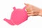 Pink teapot isolated in hand on white background