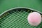 Pink tennis ball on a racket