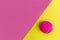 Pink tennis ball on yellow background