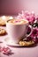 Pink themed close-up: coffee cup, cookies, and flowers create a serene setting.