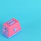 Pink toaster on bright blue background in pastel colors. Minimalism concept