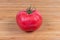 Pink tomato close-up on a wooden surface