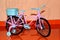 Pink toy bike. Pink and blue transport for dolls