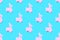 Pink toy llama money bank on blue background pattern