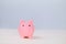 Pink toy pig on light blue background, copy space. Rosy piggy bank. Moneybox, thrift-box mockup. Savings money concept