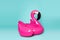 Pink, trendy, blown beach flamingo on a blue background.