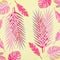 Pink tropical leaves flat lay on yellow background. Creative layout. Various tropical leaves composing