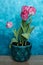 pink tulips on a blue background with copy space