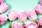 Pink tulips on the turquoise background. Flat lay, top view. Valentines background. Horizontal, copy space for text