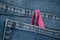 pink tweezers nail file in blue jeans pocket