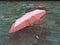 Pink Umbrella on Street cafe wet asphalt  coral  on wet rain drops evening  light   Rainy Autumn relax in Old Town empty ci