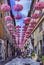 Pink umbrellas decorating the streets of Grasse, Cote d`Azur, France