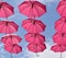 Pink umbrellas flying