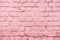 Pink uneven brick wall close-up