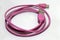 Pink used USB plug with cable on the white background.