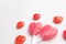 Pink Valentine`s day heart shape lollipop with small red candy in cute pattern on empty white paper background. Love Concept. Min