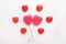 Pink Valentine`s day heart shape lollipop small red candy in cute pattern on empty white paper background. love concept. top view.