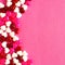 Pink Valentines Day background with candy heart border