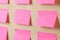 pink various notes or sticky post-it on wooden office table background .mockup.