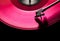 Pink vinyl disc. close-up. techno music. black background,