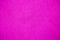 Pink vivid bright color coarse facade wall as an empty rustic texture background