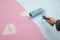 Pink wall of baby room is painted blue with hand and roller