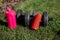 Pink water bottle, two black dumbbells and red musical  column