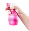 Pink water pulverizer spray in female hand cloe up isolated on white background.